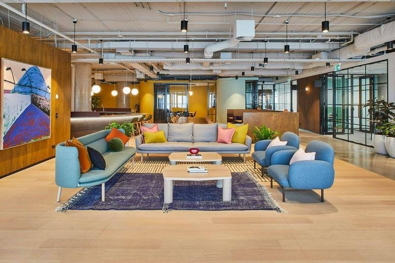 Spacious lounge area with colorful seating and artwork.