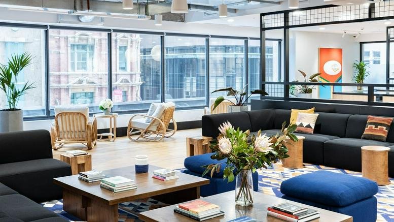 Spacious sunlit lounge at 320 Pitt Street, Sydney with floor-to-ceiling windows and modular seating.