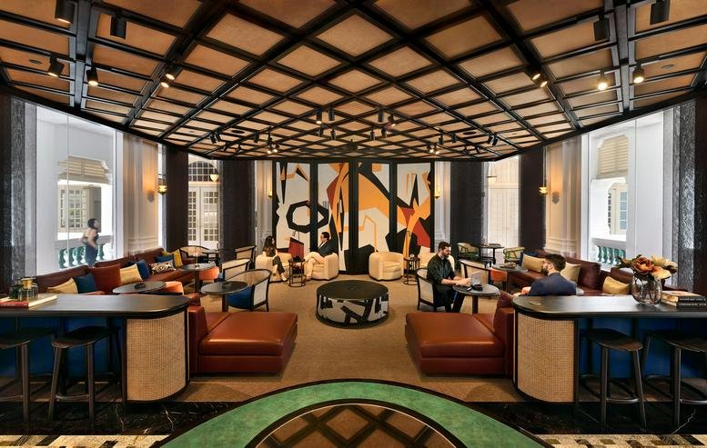 Spacious communal lounge at 328 North Bridge Road, Raffles Hotel Arcade, Singapore with decorative wood lattice ceiling.