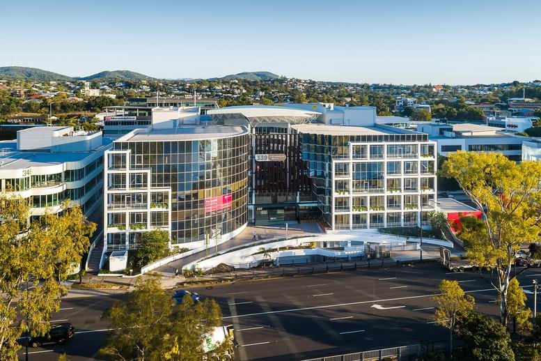 Wide exterior view of the contemporary curved glass office building at 339 Coronation Drive, Milton.