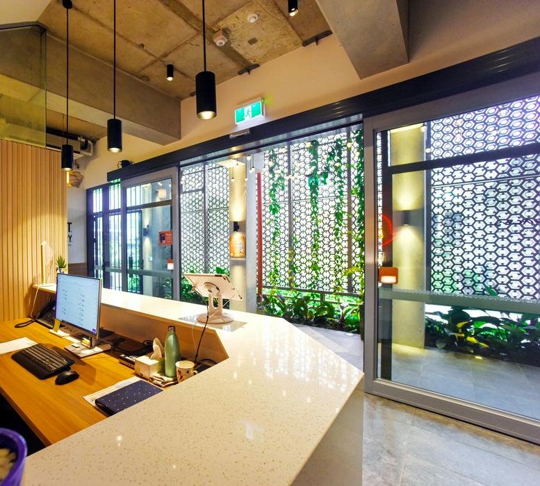 Modern reception desk at 36 Abbott Street, Cairns, Queensland with stone counters and a decorative glass screen.