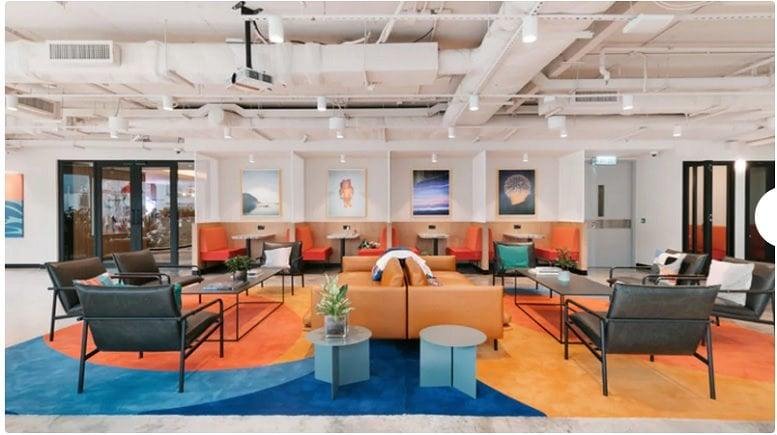 Spacious communal lounge at Ground Floor, 36 Infantry Road with colorful rugs and modern seating.