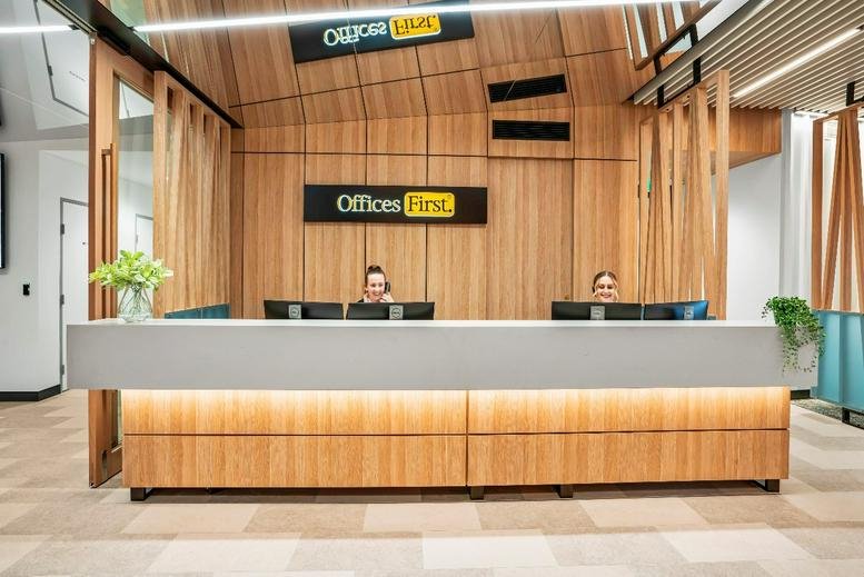 Reception area at 36 Marine Parade Commercial Tower (L10) with wood paneling and a long grey desk.