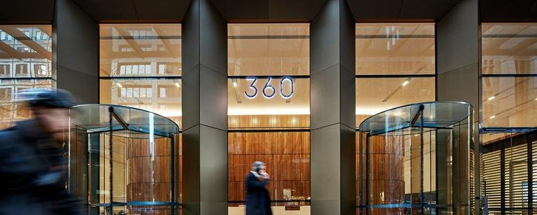 Entrance to 360 Collins Street featuring glass revolving doors and building signage.