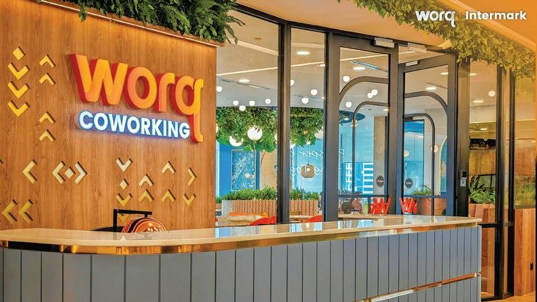 Branded reception counter at Integra Tower featuring wood paneling and warm lighting.