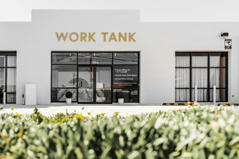 Exterior view of the white facade and entrance of Work Tank at 384 Keilor Road.