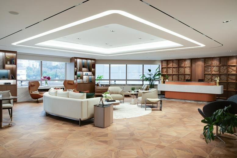 Large contemporary reception area featuring a square illuminated ceiling and wood flooring.