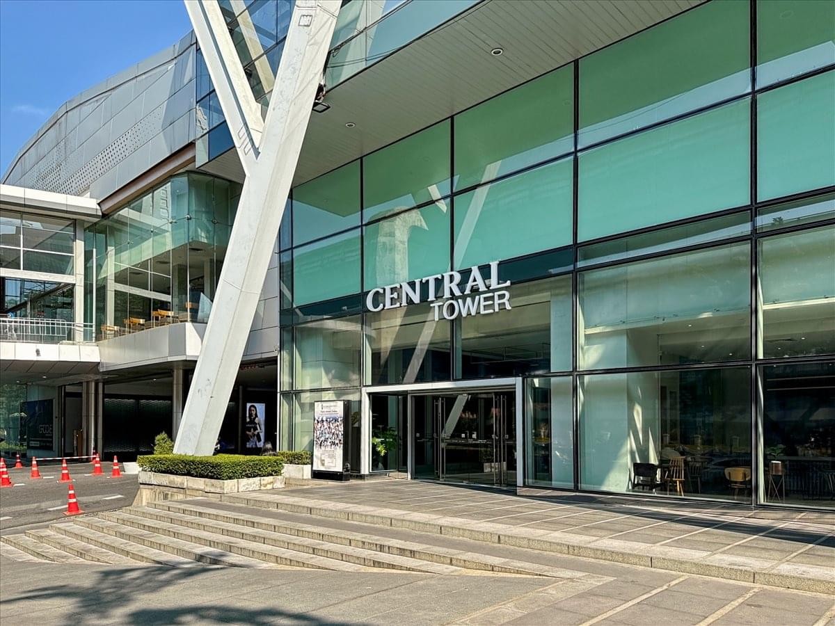 Ground level exterior view of the glass entrance to Central Tower.