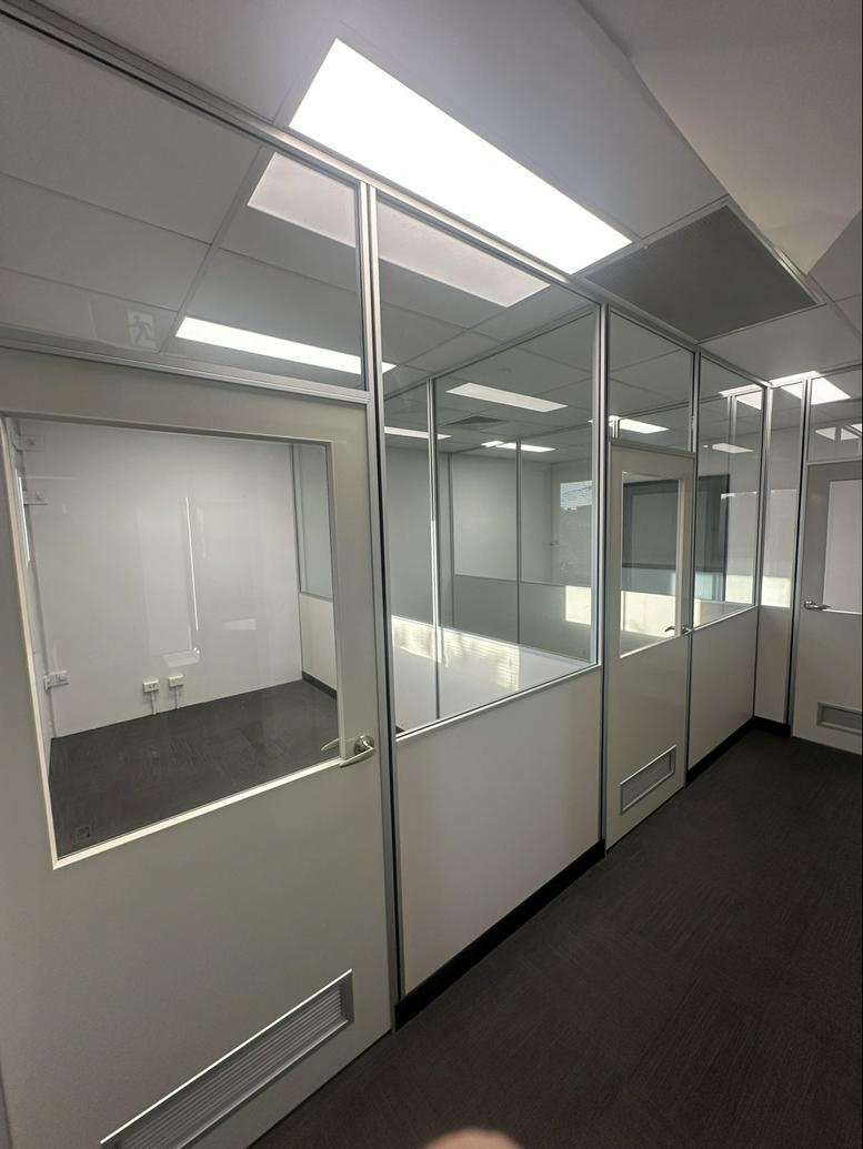 Professional suites at 40, Leonard Crescent, Unit 1, featuring glass partitions and modern lighting.