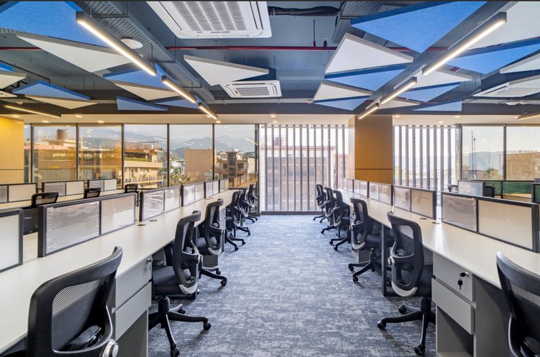 Spacious open-plan workspace at 43-A, IT Park, Sahastradhara Road, Dehradun with vibrant blue ceiling panels.