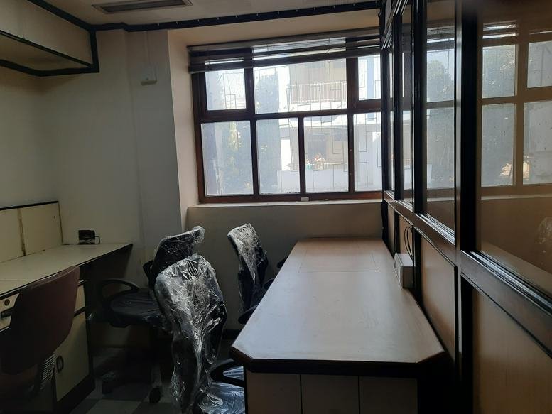 Private office at 43, Palace Court with a large window and wood-framed glass partitions.
