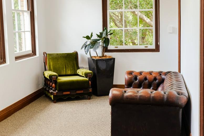 Lounge area at 44 & 46, The Barracks Precinct, North Head Sanctuary, Sydney with vintage velvet and leather seating.
