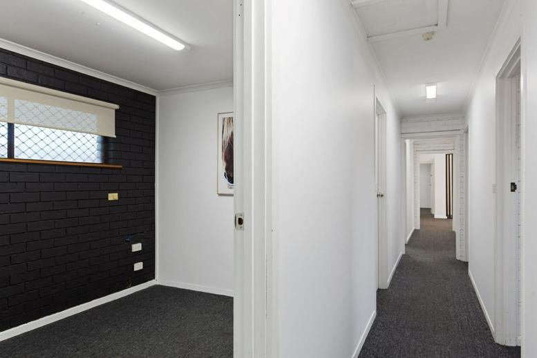 Bright hallway at 44 Osborne Road leading to private office spaces.