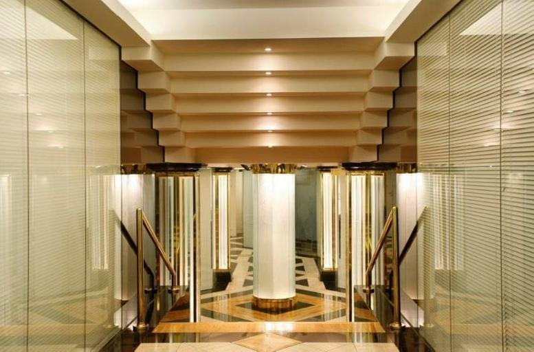 Symmetrical hallway at 459 Toorak Road, Toorak, Melbourne featuring tiered ceiling lights and glass partitions.