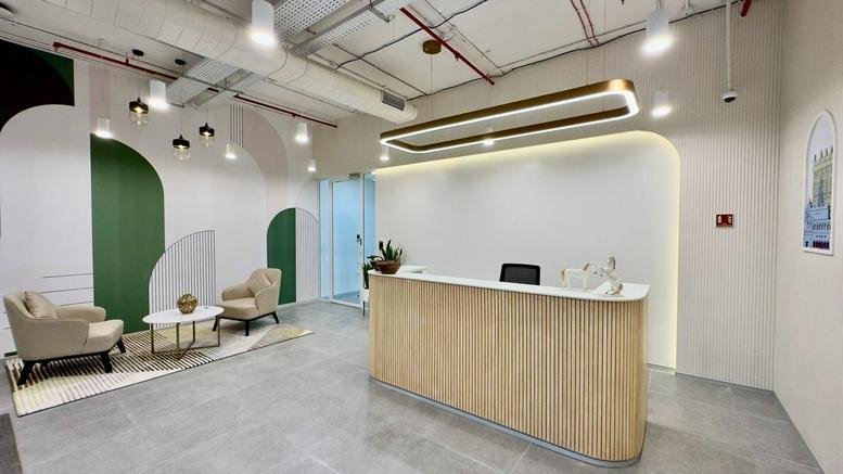 Bright, modern reception area at 45ICON, Baner Road, Pune, India with a wood-slat desk and green arched wall accents.