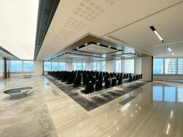 Spacious auditorium-style event space with rows of black chairs at The Center.