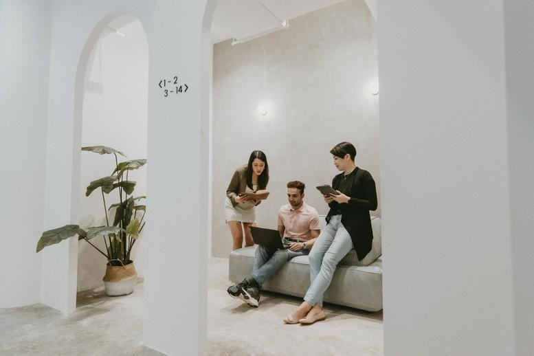 Spacious communal lounge at 48, Jalan SS 21/39, Damansara Utama, Petaling Jaya with people and potted plants.