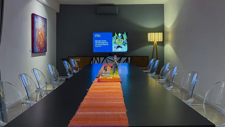 Spacious boardroom at 48A Vo Van Tan Street featuring a long black table and modern transparent chairs.