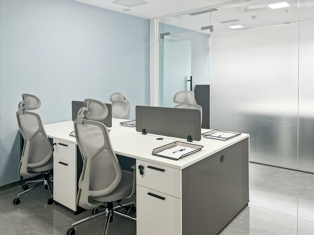 Four-person workstation area with ergonomic mesh chairs and white desks at 496 Wenwu West Road.