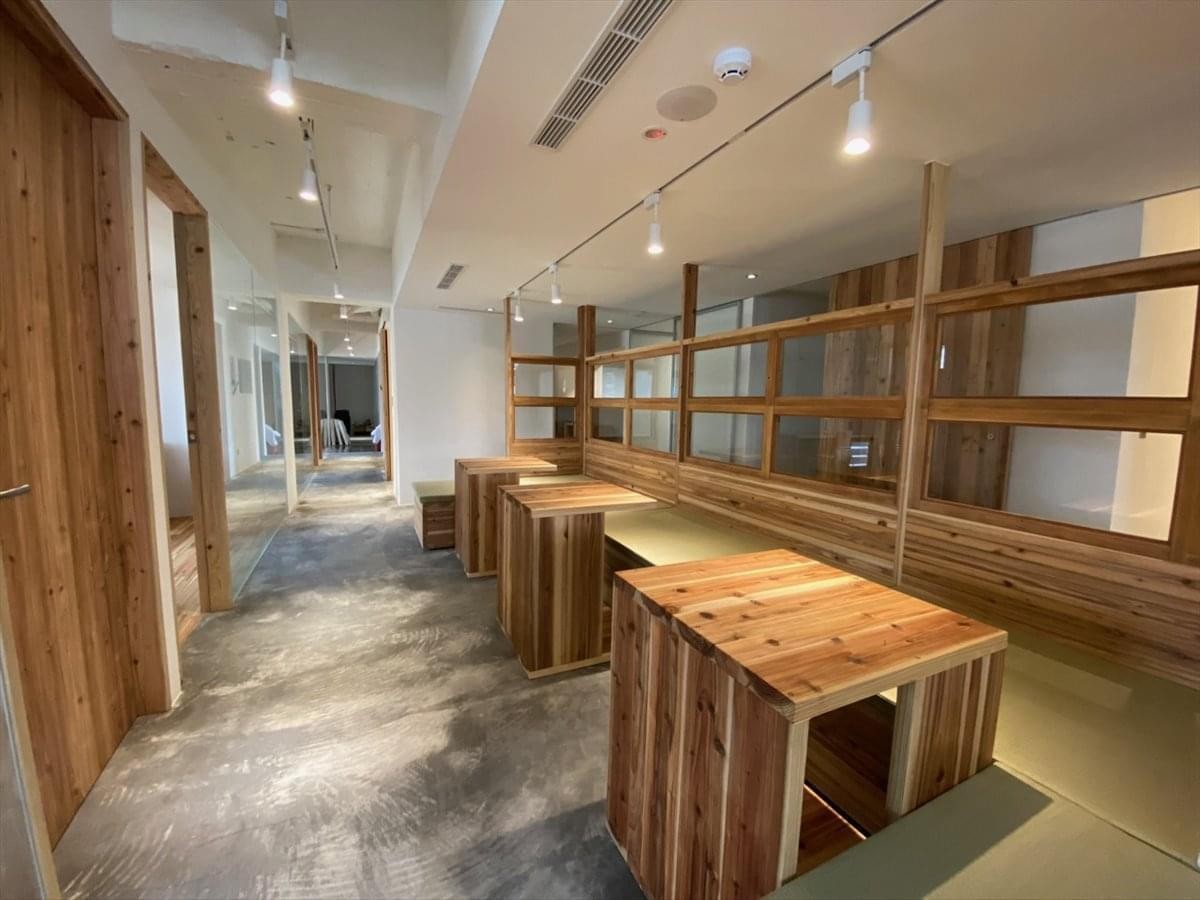 Spacious interior at 59 Section 4, Zhongxiao E. Rd, Da’an Dist, Taipei with wooden desks and glass partitions.