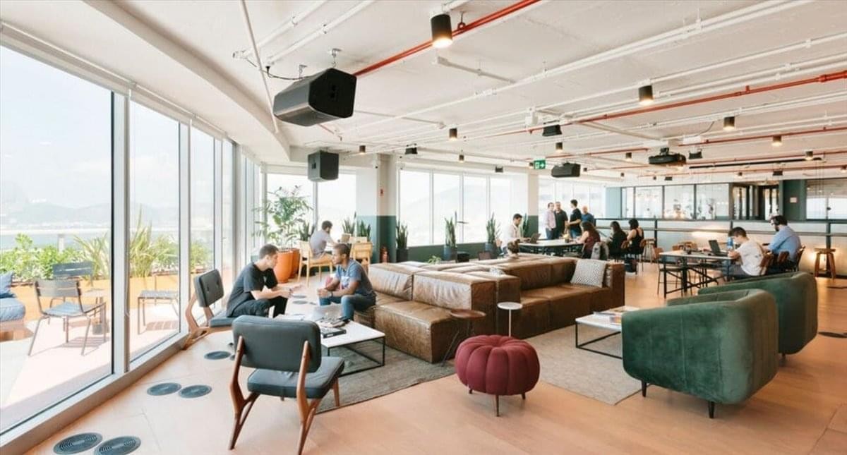 Spacious communal lounge at Spectrum Tower, 4th Floor, with panoramic windows and comfortable seating areas.
