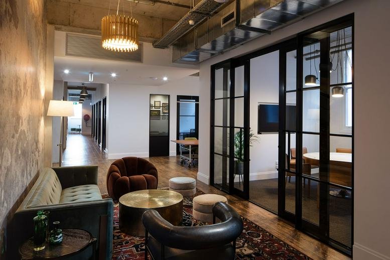 Spacious communal lounge at 5 Alexander Street, Crows Nest with velvet armchairs and a decorative rug.