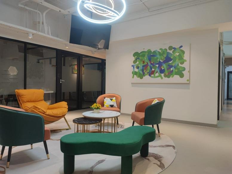 Colorful communal lounge at New Timely Factory Building with modern furniture and abstract art.
