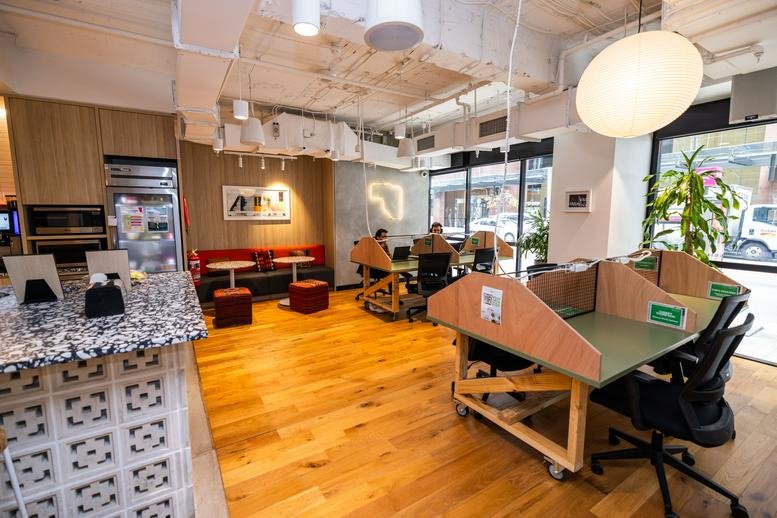 Spacious communal breakout area at 50 Miller Street, Sydney with wooden floors and natural light.