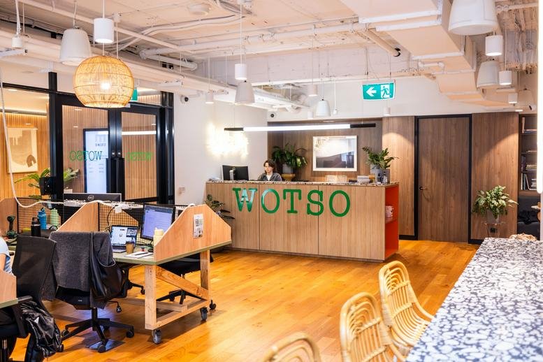 Modern reception area at WOTSO North Sydney, 50 Miller Street with timber desk and branded signage.