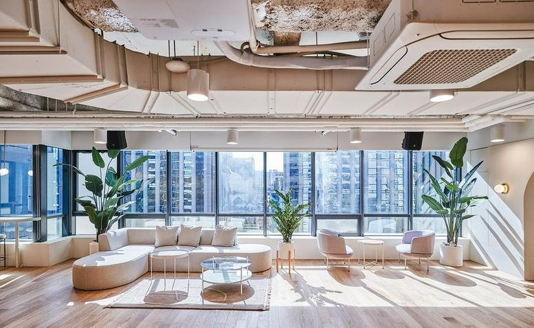 Spacious sunlit lounge at 503 Teheran-ro, Samsung 3 with modular sofas, potted palms, and floor-to-ceiling windows.