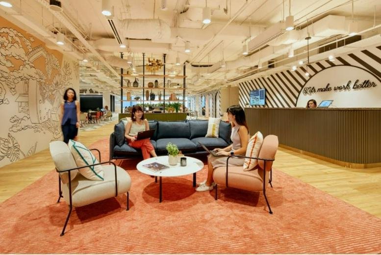 Spacious reception and lounge at 51 Bras Basah Road, Bencoolen, Singapore featuring a curved desk and soft seating.