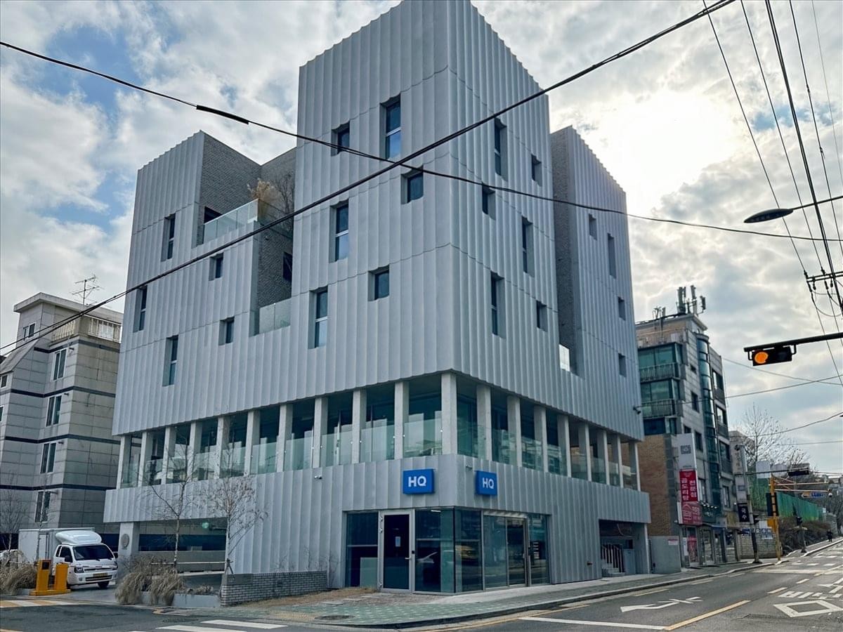 Exterior view of the modern, textured grey facade of the Dotwave building at 54 Eunhaengjeong-Ro.