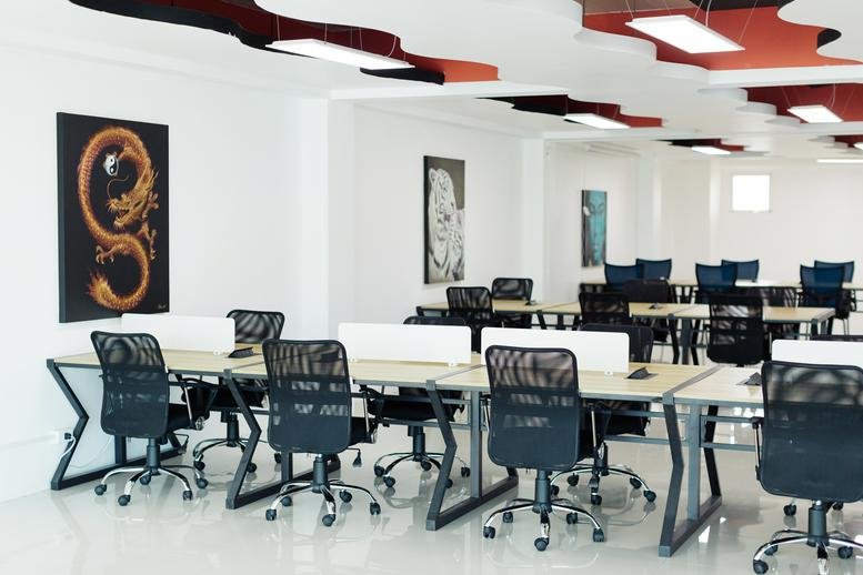 Modern open-plan office at 59 Chao Fah Tawan Tok Rd with wave-patterned ceilings.
