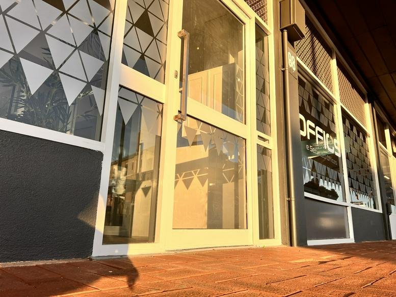 Entrance to 598 Albany Highway showing glass doors with geometric frosting.
