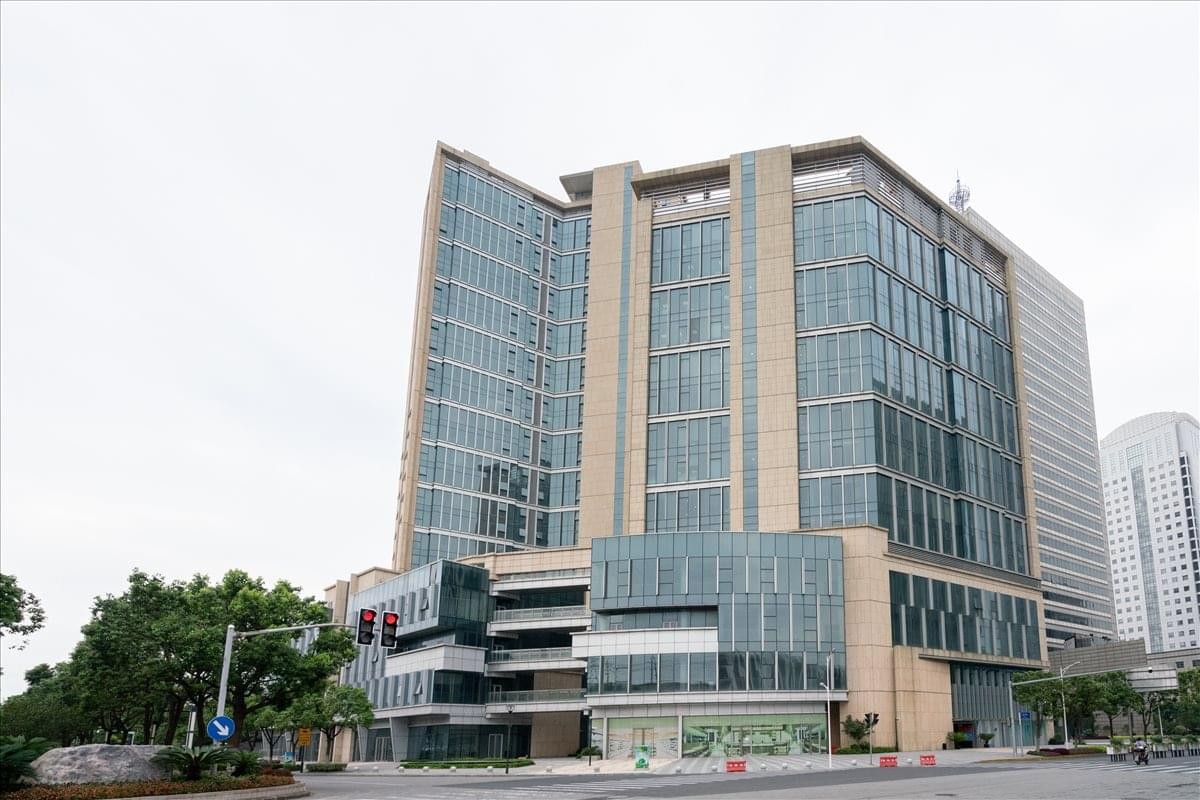 Exterior view of the glass and stone facade of Zhenfeng Plaza.