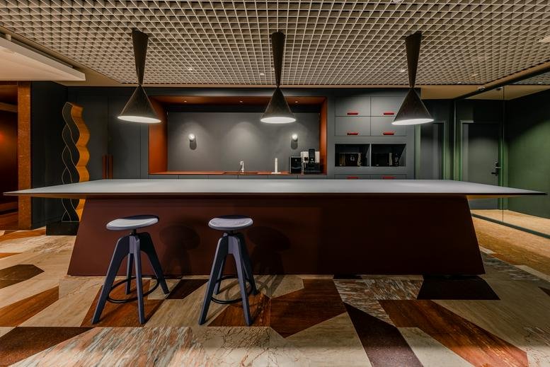 Modern communal pantry area at 6 Battery Road, No. 03-01, Raffles Place, Singapore with a large island and bar stools.