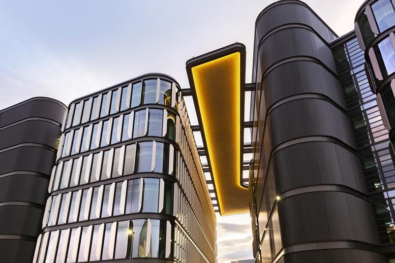 Unique exterior architecture of the 6 Brindabella Circuit building with curved glass facades.