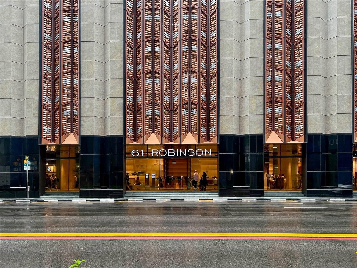 Street-level view of the modern facade and entrance at 61 Robinson Road.