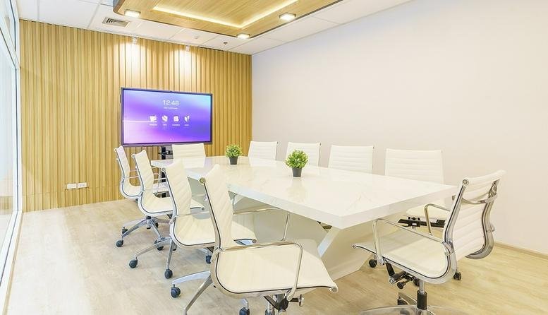 Modern boardroom at 622, Sukhumvit Road with a large screen and wood-slat feature wall.