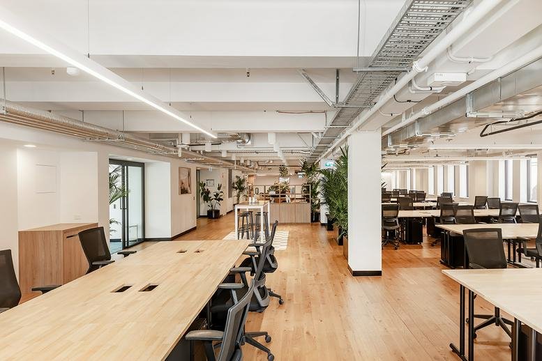 Wide view of King Street Studios featuring light wood floors and an open-plan office layout.