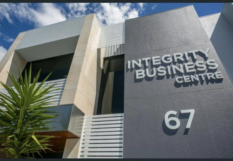 Modern exterior of the Integrity Business Centre at 67 Howe Street with a grey and tan facade.