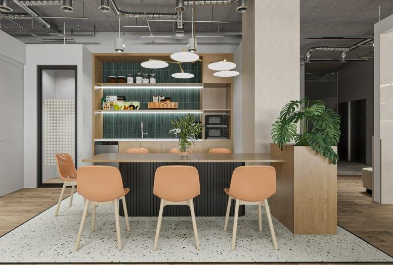 Modern communal breakout space at 67 Nguyen Thi Minh Khai, Ben Thanh Ward with a kitchen and orange chairs.