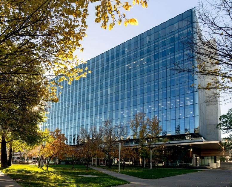 Exterior view of the glass-facade building at 68 Northbourne Avenue, Canberra.