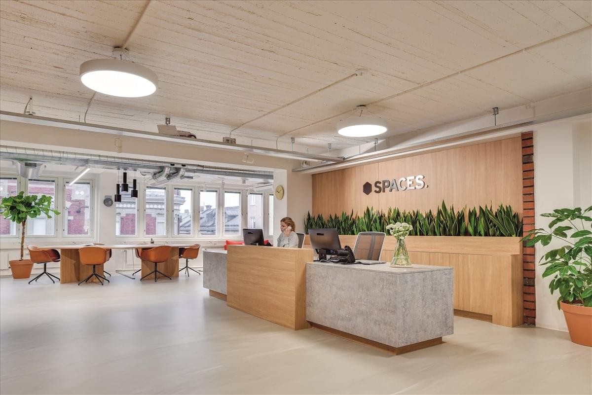 Spacious wooden reception desk at Level 38, 71 Eagle Street, Brisbane, Queensland with green plants and warm lighting.