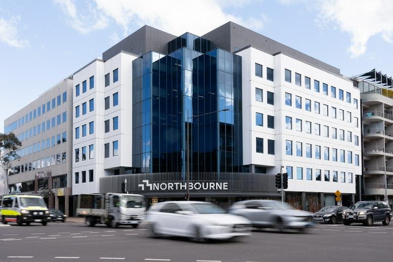 Exterior view of the white and glass office building at 73 Northbourne Avenue.