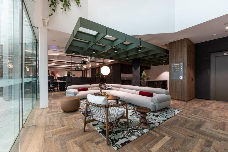 Spacious lobby lounge at 79 St Georges Terrace with a green feature ceiling and plush curved sofa.