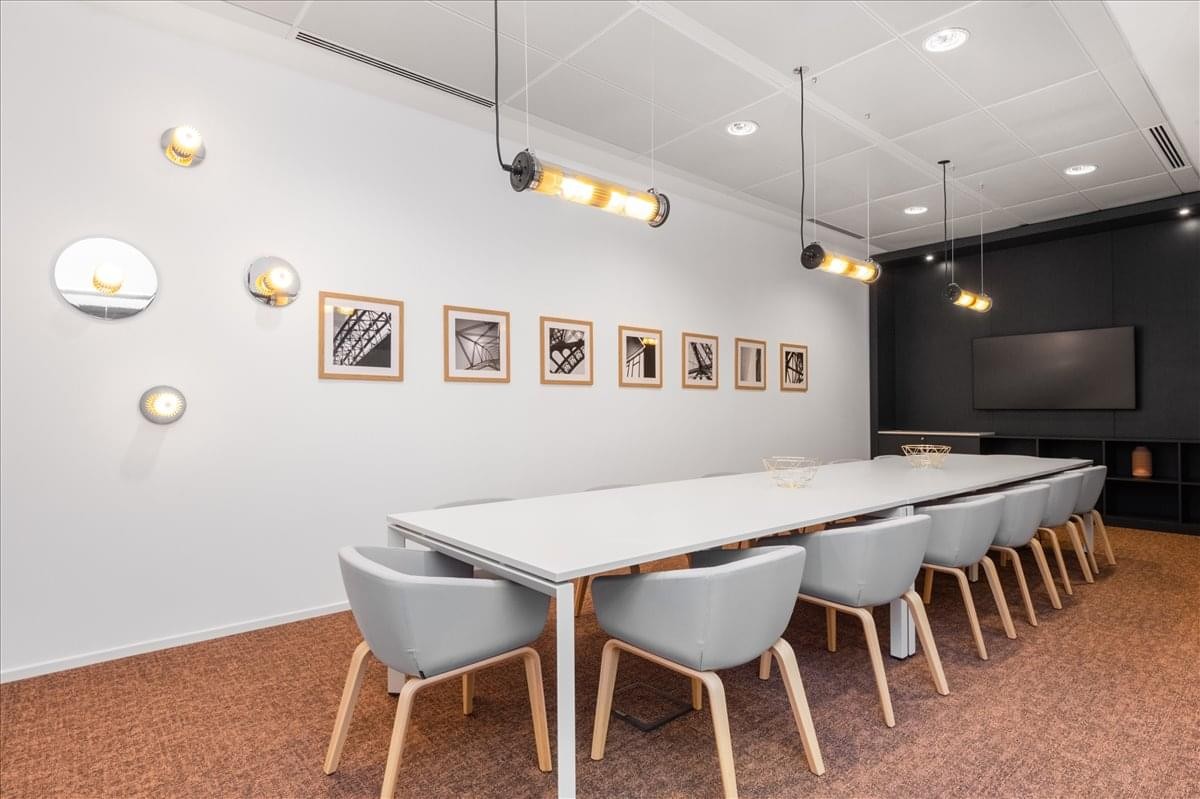 Meeting room with a long white table and modern tube lighting at Gran Green Osaka Gate Tower.