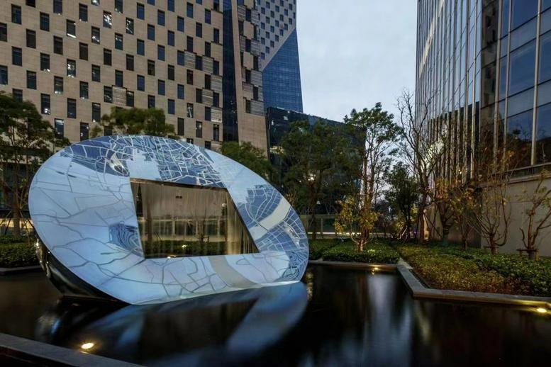 A modern circular sculpture and water feature outside 7th, 9th Floor Building B at 159 Jiangjin Road.