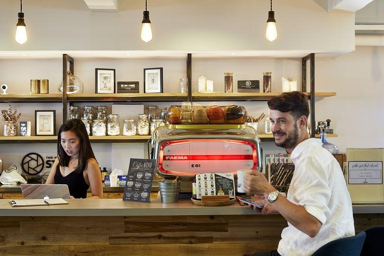 Cafe area with an espresso machine and barista at 8/F Cheung Hing Industrial Building, 12P Smithfield Road.