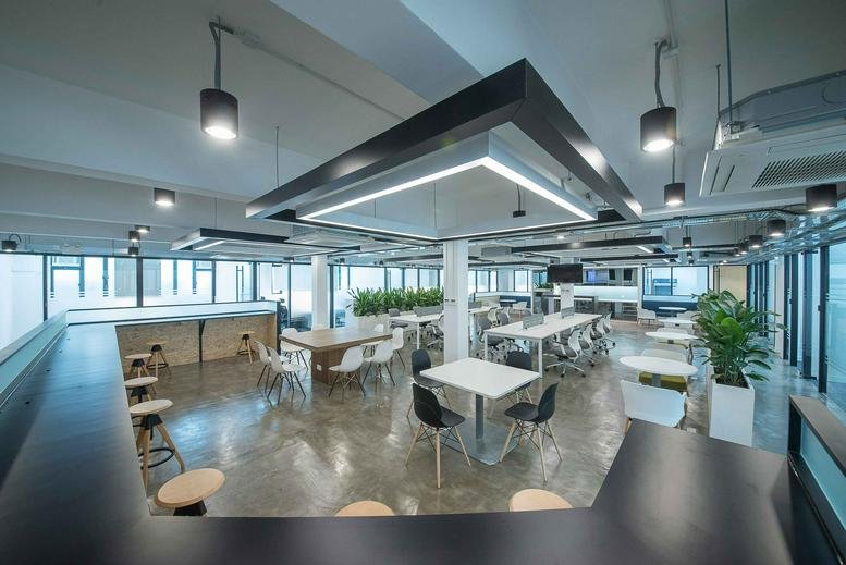 Spacious communal area with various seating options and large windows.